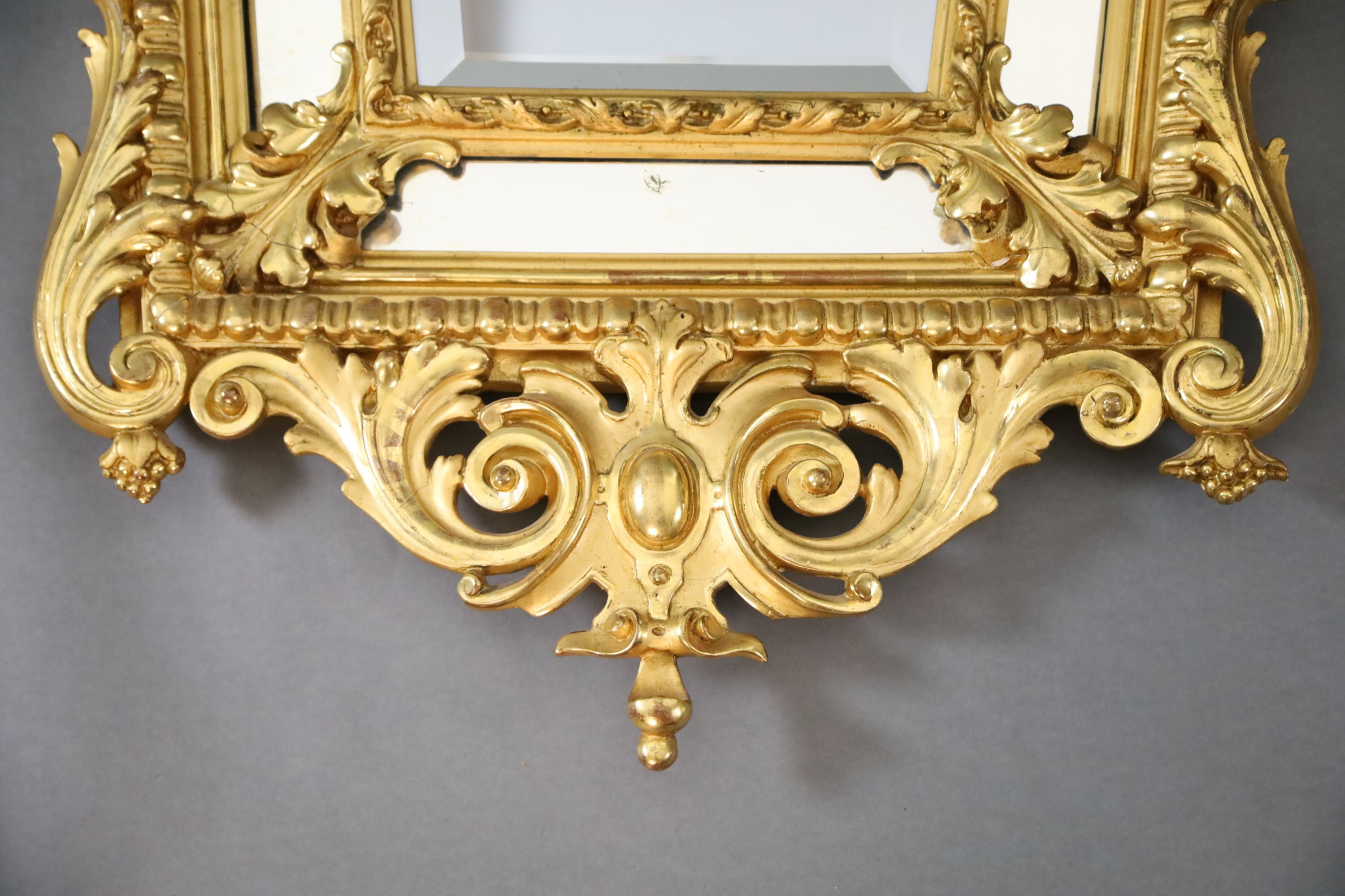 A Louis XIV style carved giltwood wall mirror, W.3ft 1in. H.5ft 1in.